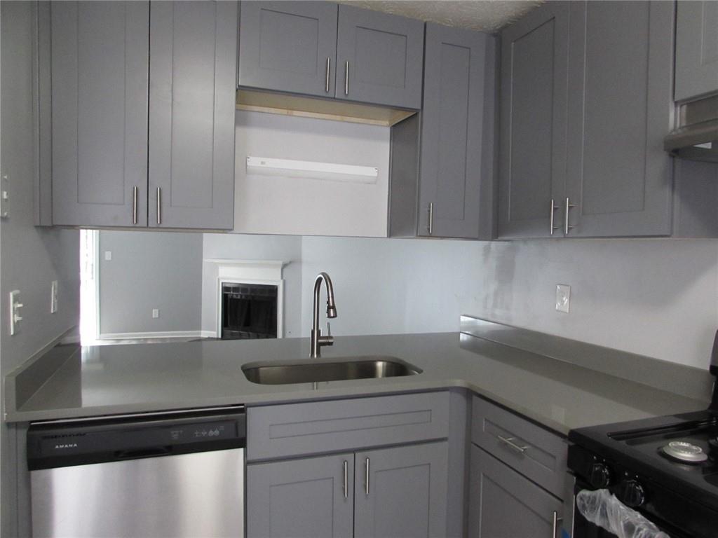 835 Heritage Valley Road Norcross, GA 30093 - Photo 7 of 34 a kitchen with a sink and cabinets