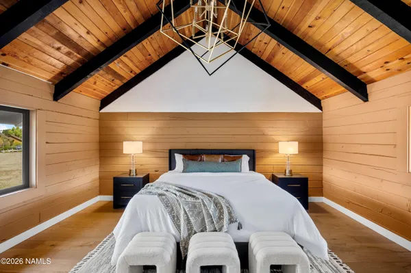 a bed sitting in a bedroom next to a window