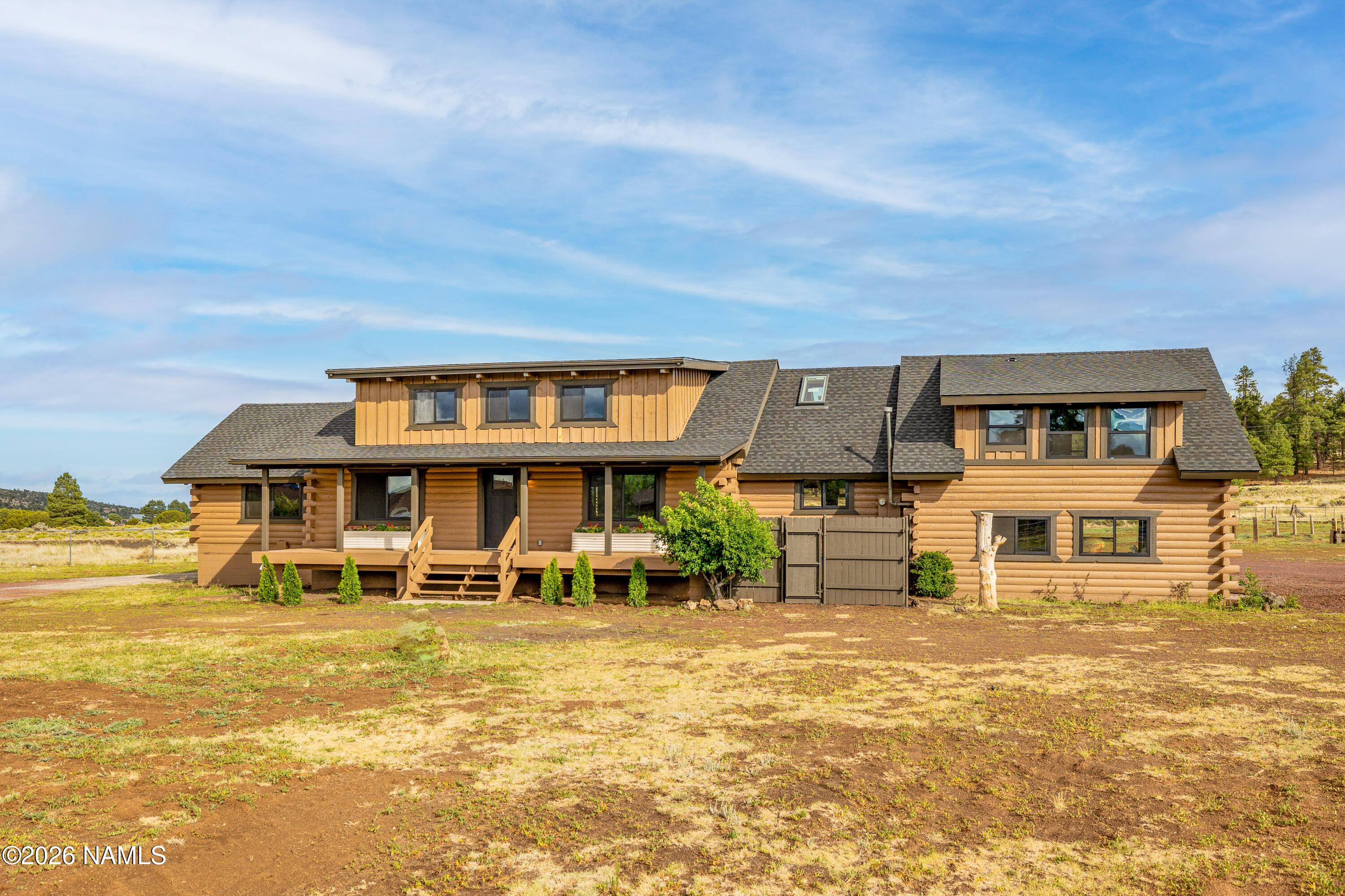 8191 June Lane Flagstaff, AZ 86004 - Photo 2 of 45 a front view of a house with a big yard
