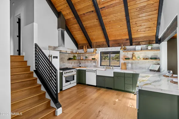a kitchen with stove and cabinets