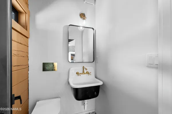 a bathroom with a toilet sink and mirror