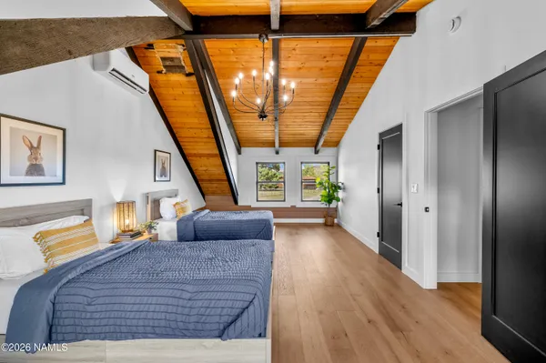 a bedroom with a large bed and a couch