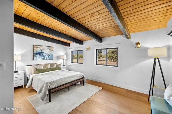 a bedroom with a bed and a wall painting