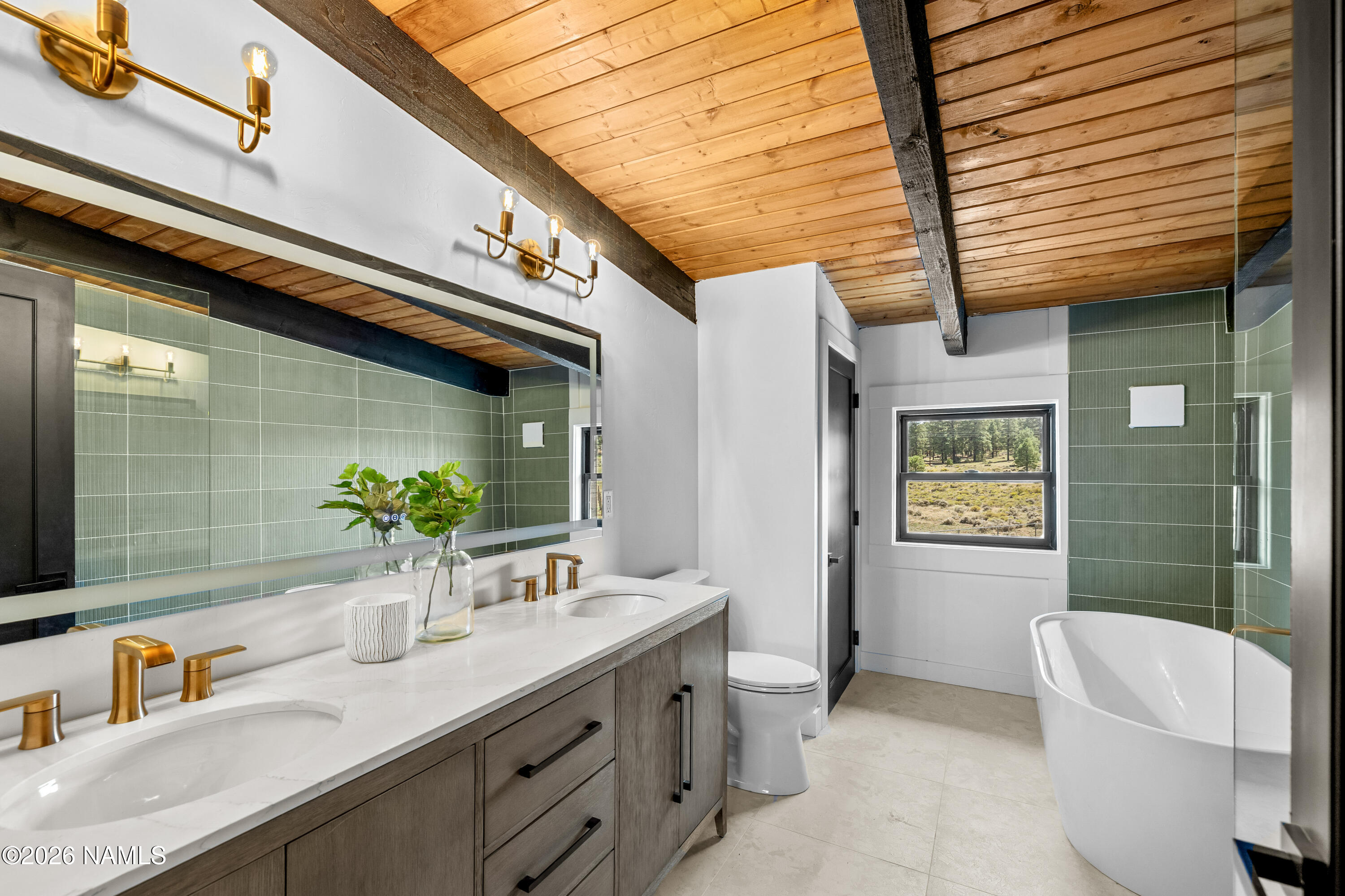 8191 June Lane Flagstaff, AZ 86004 - Photo 41 of 45 a bathroom with a granite countertop sink and a large mirror