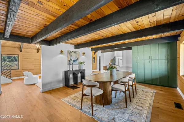 a dining room with furniture and wooden floor