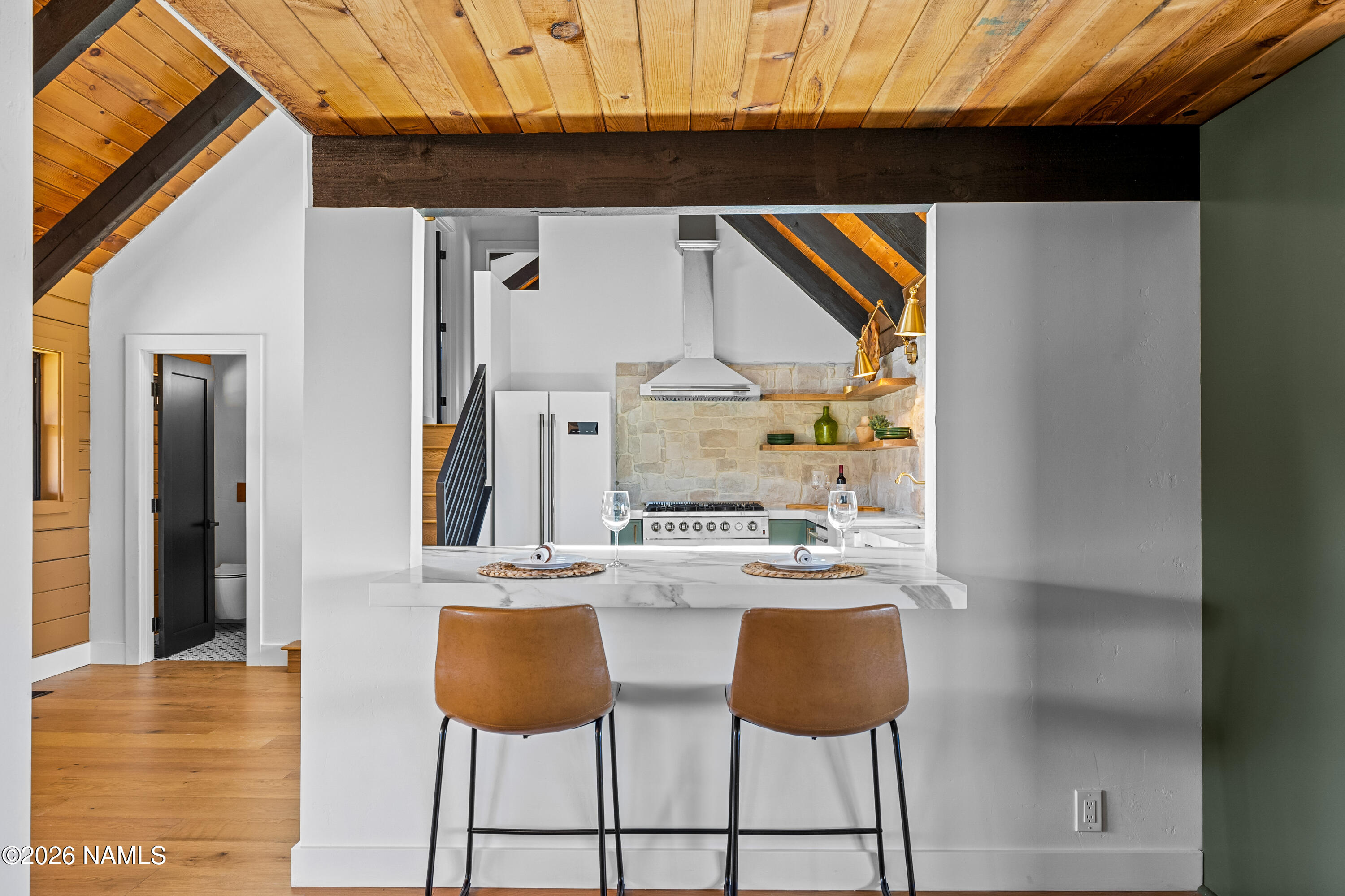 8191 June Lane Flagstaff, AZ 86004 - Photo 9 of 45 a kitchen with stainless steel appliances granite countertop a stove and a chair