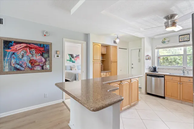 a kitchen with stainless steel appliances granite countertop a refrigerator and microwave