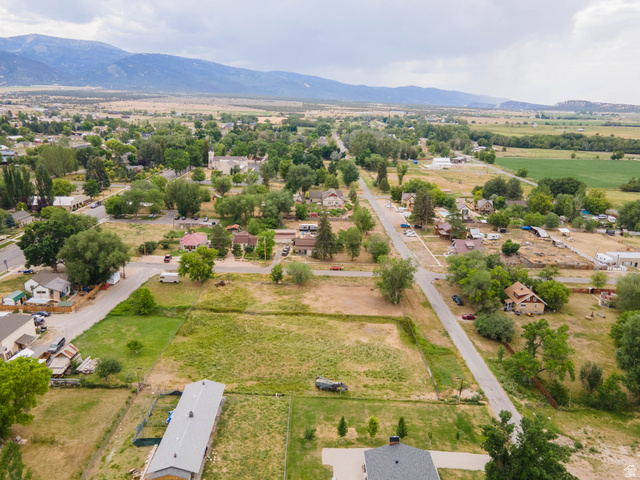 74 West Ctr Spring Spring City, UT 84662 - Photo 8 of 15 Expansive undeveloped land parcel surrounded by mature trees, residential properties, and distant mountains