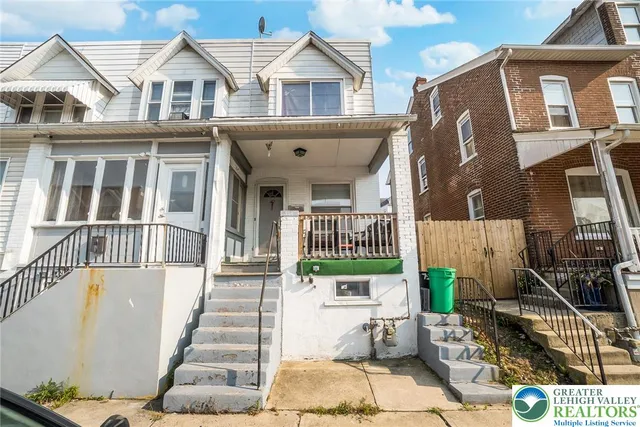a view of a brick house with many windows