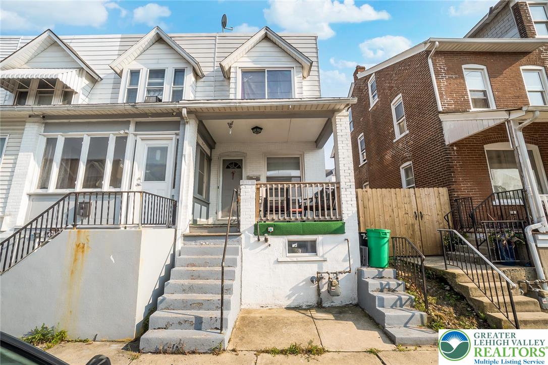 a view of a brick house with many windows