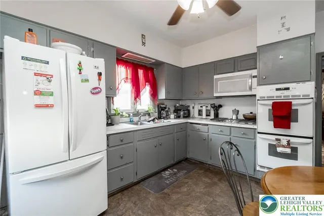 a kitchen with stainless steel appliances a refrigerator sink and cabinets