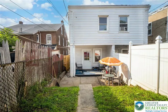 a view of a house with backyard and porch