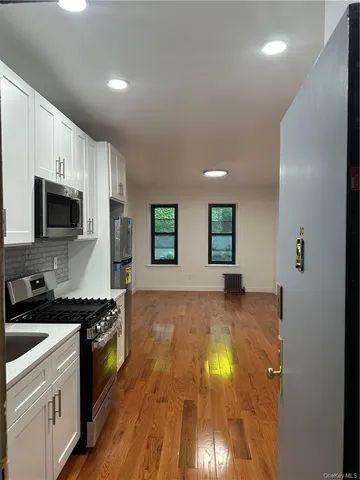 a kitchen with granite countertop a stove and a sink