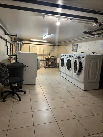 a utility room with lots of appliances and cabinets