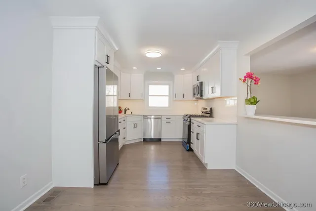 a kitchen with a refrigerator and a sink