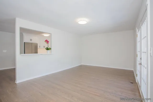 an empty room with wooden floor and closet