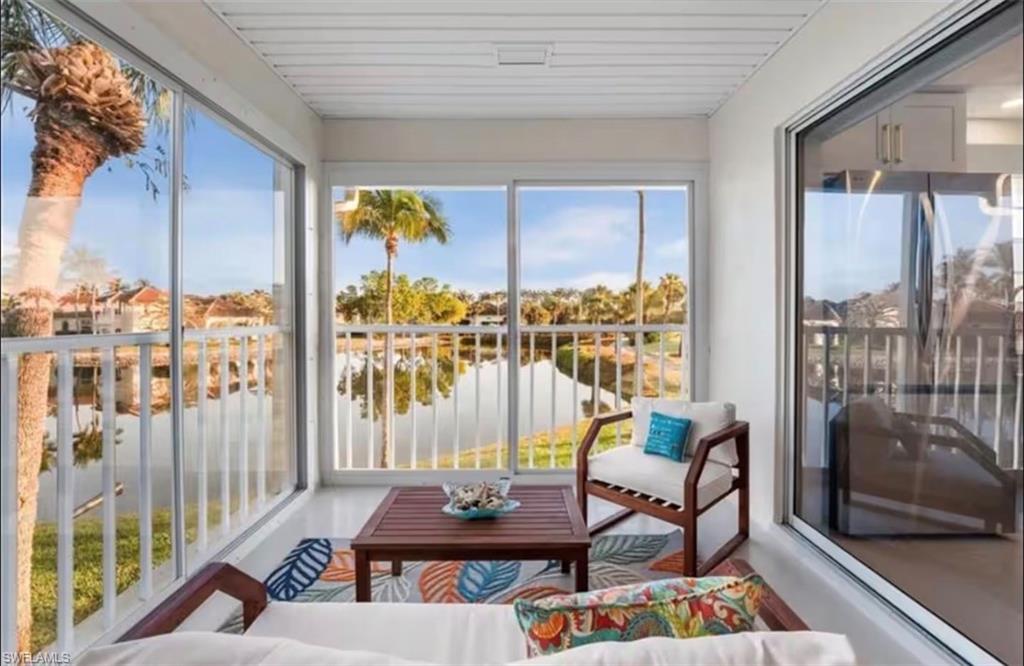 14993 Rivers Edge Court, Unit 246 Fort Myers, FL 33908 - Photo 10 of 23 a living room with furniture and a floor to ceiling window