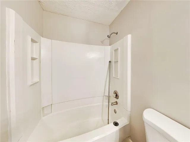 a bathroom with a shower and a toilet
