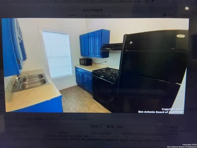a kitchen with wooden cabinets and a sink