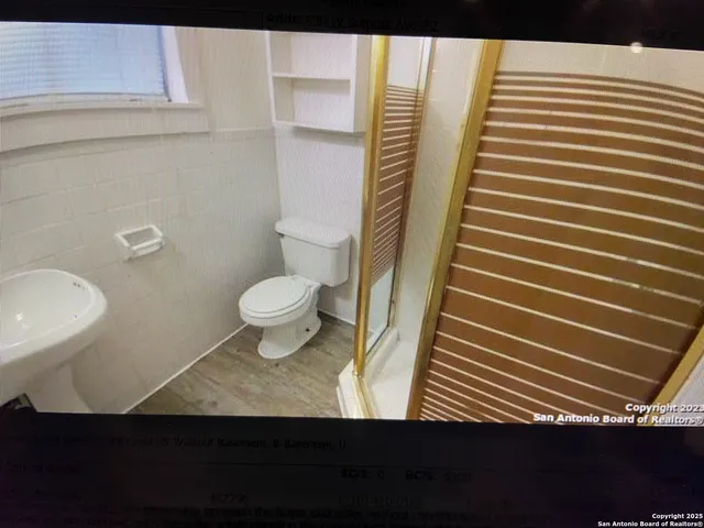 a view of bathroom with toilet and shower