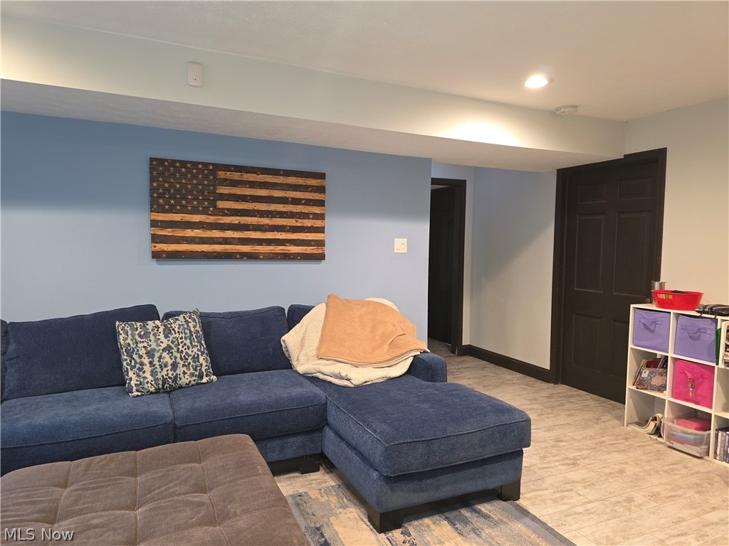 2868 Shade Road Akron, OH 44333 - Photo 29 of 49 Recessed lighting illuminates this space featuring light blue walls and wood-finish flooring