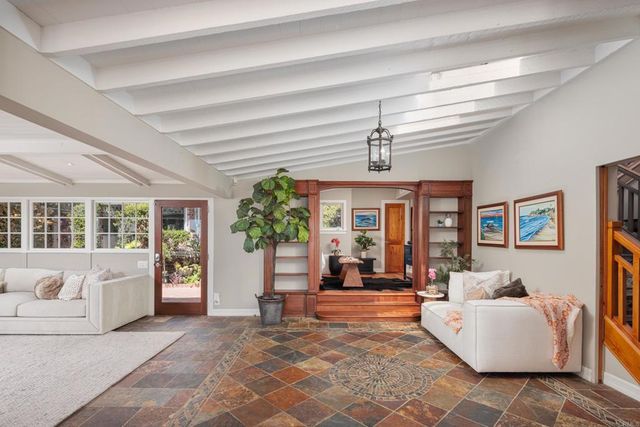 a living room with furniture and a chandelier