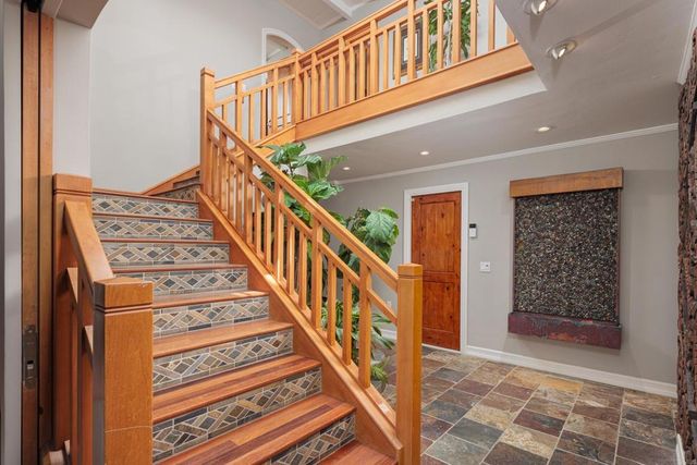a bedroom with a large bed and wooden floor