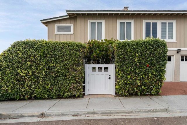 a room with stainless steel appliances granite countertop a lot of cabinets a sink dishwasher and a stove with wooden floor