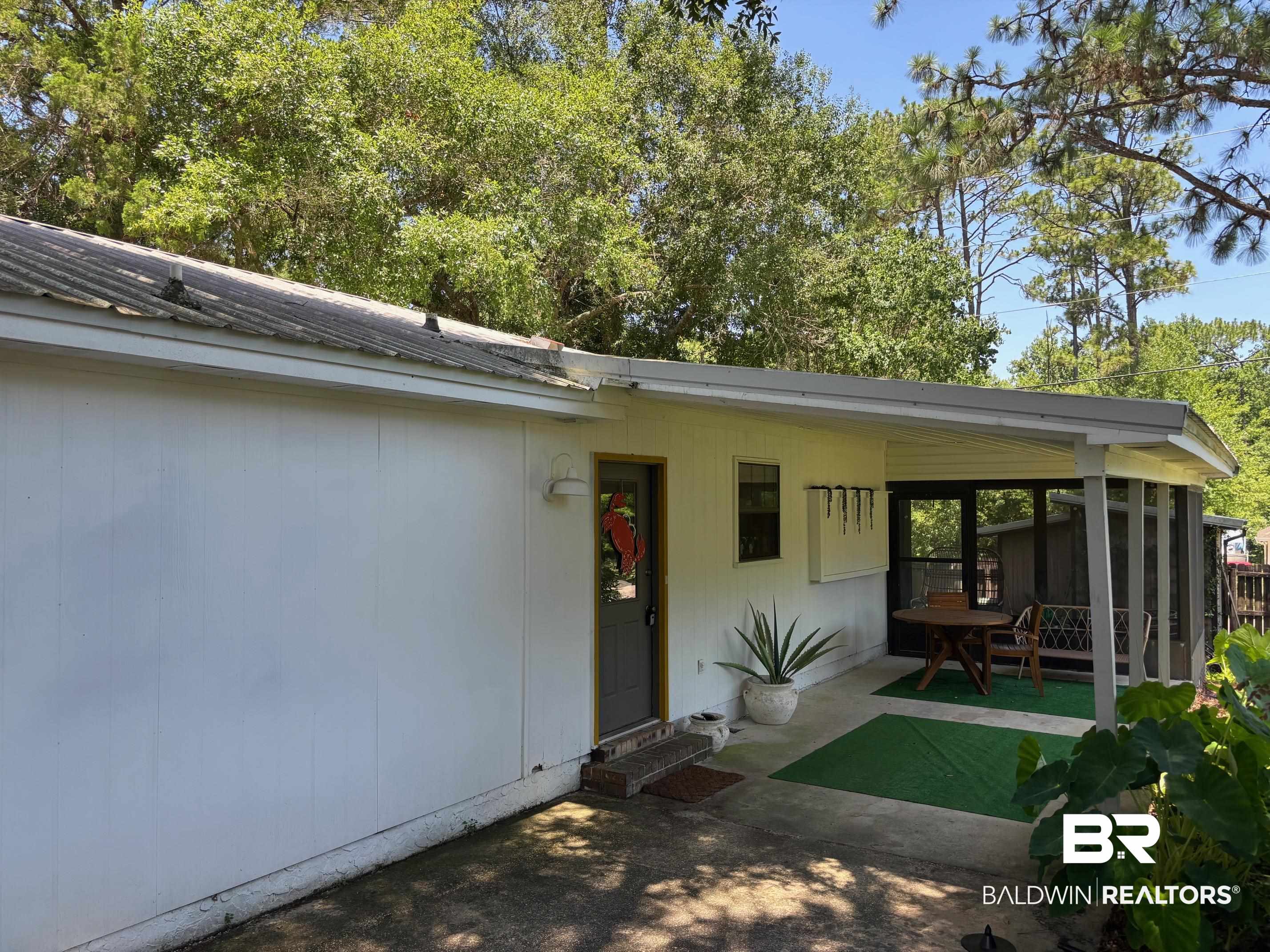 1434 Ridgewood Drive Lillian, AL 36549 - Photo 5 of 45 Property entrance featuring a metal roof and a patio