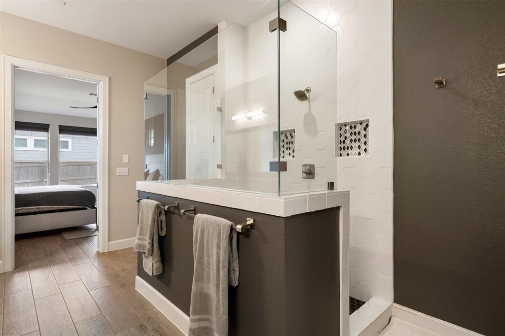 1012 Quarry Point Pass Leander, TX 78641 - Photo 21 of 39 Luxurious walk-in shower with contemporary tile work and integrated storage niches.