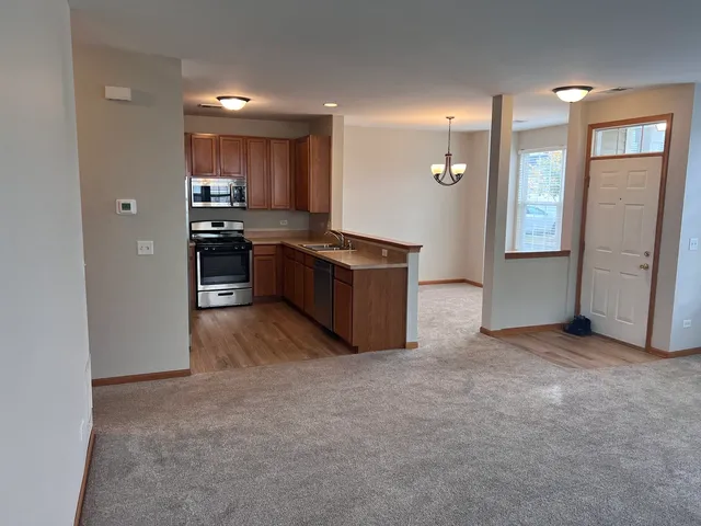 a kitchen with stainless steel appliances granite countertop a refrigerator and a stove