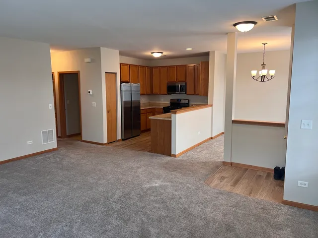 a view of kitchen with refrigerator and microwave
