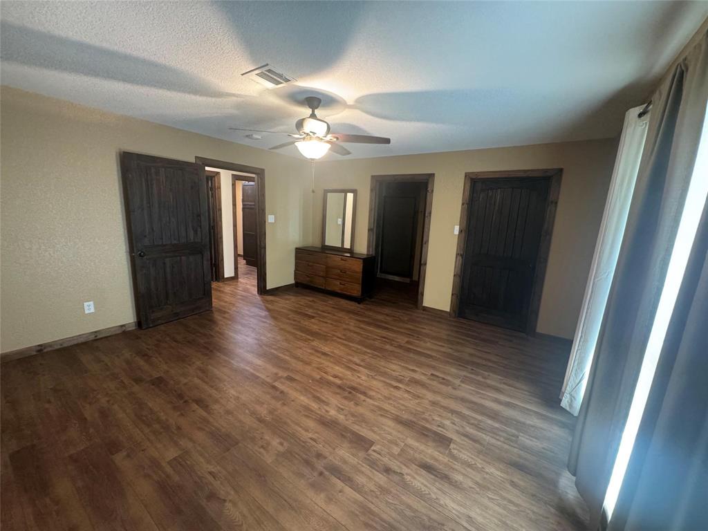 377 Private Road 3249, Unit ARENA Decatur, TX 76234 - Photo 33 of 40 wooden floor in an empty room with a window