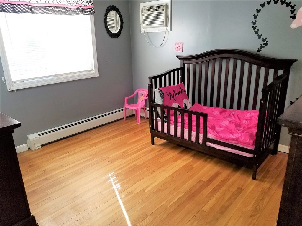79 Restful Valley Road Tiverton, RI 02878 - Photo 11 of 18 bedroom 2 with hardwood floors and built in AC unit