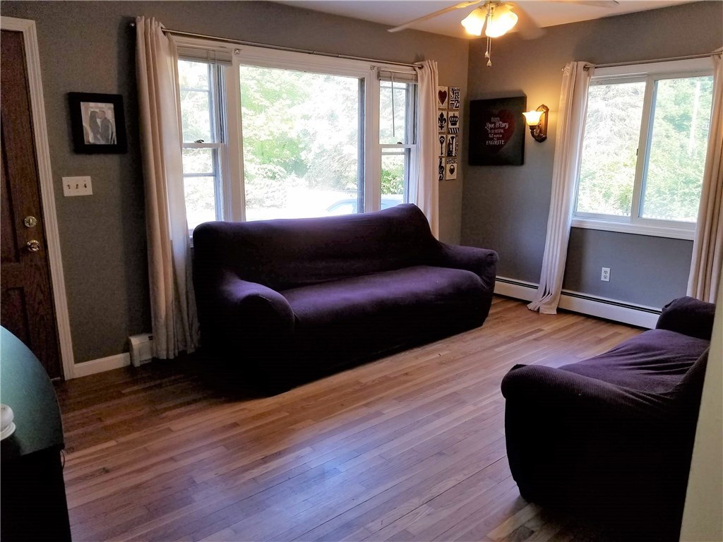 79 Restful Valley Road Tiverton, RI 02878 - Photo 7 of 18 family room with lots of light and hardwood floors