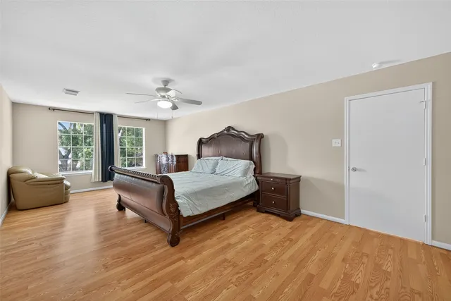 a bedroom with a large bed and a couch