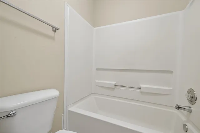 a bathroom with a bathtub and toilet