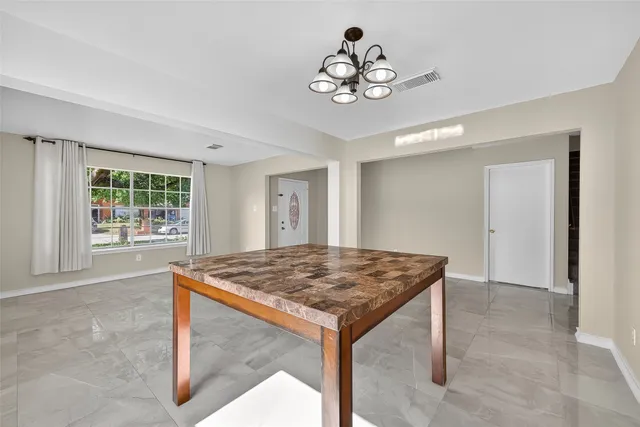 a view of a room with a table and chairs