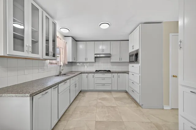 a kitchen with stainless steel appliances granite countertop a sink and cabinets