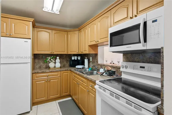 a kitchen with stainless steel appliances a stove microwave and cabinets