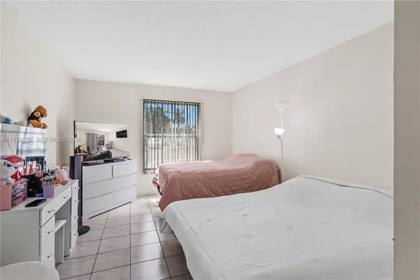 a bedroom with a bed and glass window