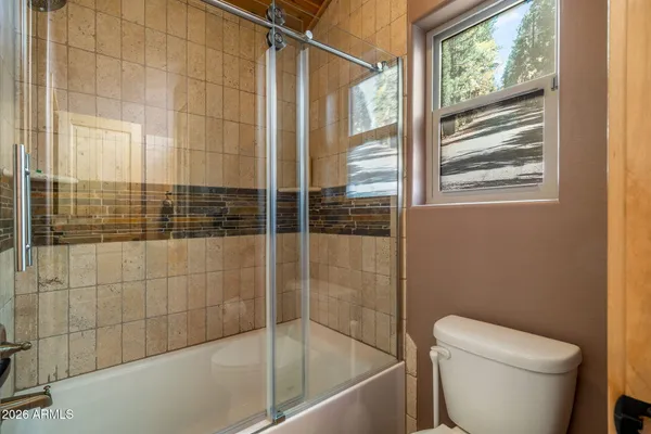 a bathroom with a glass shower door