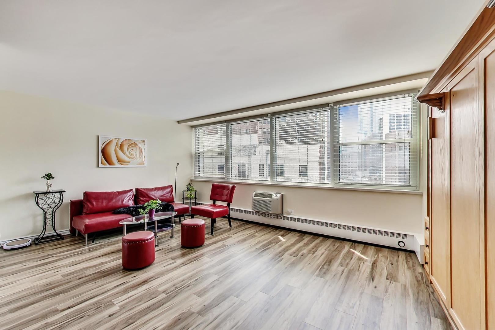 1150 North Lake Shore Drive, Unit 11J Chicago, IL 60611 - Photo 11 of 34 a living room with furniture and a wooden floor