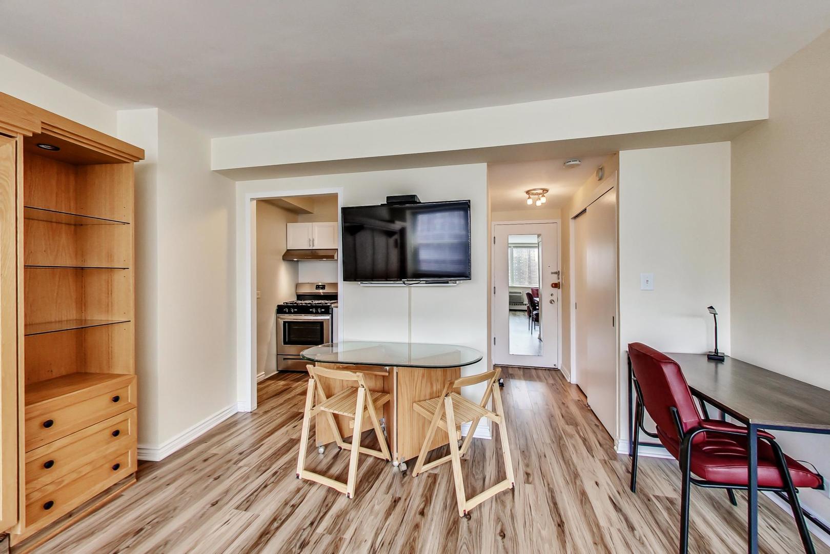 1150 North Lake Shore Drive, Unit 11J Chicago, IL 60611 - Photo 12 of 34 a living room with furniture and a wooden floor