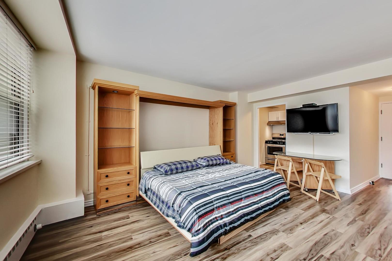 1150 North Lake Shore Drive, Unit 11J Chicago, IL 60611 - Photo 14 of 34 a bedroom with a bed and a flat screen tv