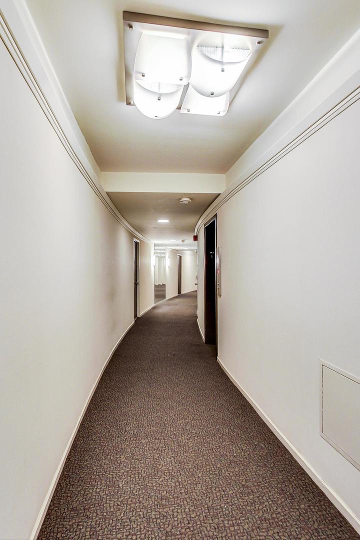 1150 North Lake Shore Drive, Unit 11J Chicago, IL 60611 - Photo 28 of 34 a view of a hallway with a window