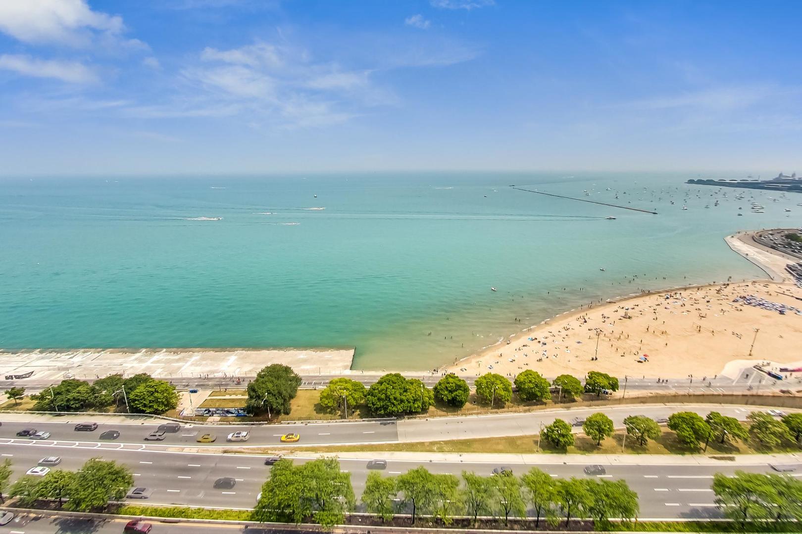 1150 North Lake Shore Drive, Unit 11J Chicago, IL 60611 - Photo 32 of 34 a view of lake with lots of car parked