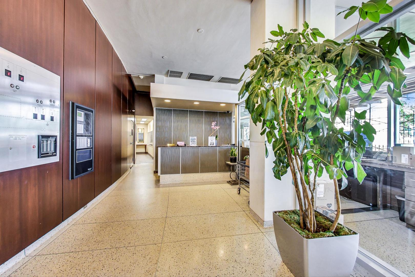 1150 North Lake Shore Drive, Unit 11J Chicago, IL 60611 - Photo 7 of 34 a lobby with furniture and potted plants