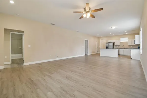a view of a kitchen with a sink and a refrigerator