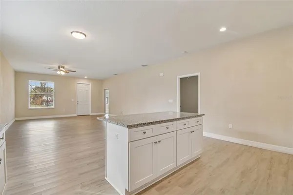 a view of a kitchen with a sink and dishwasher with wooden floor